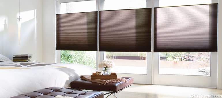 Minimal Bakersfield bedroom with high windows and vertical honeycomb shades.