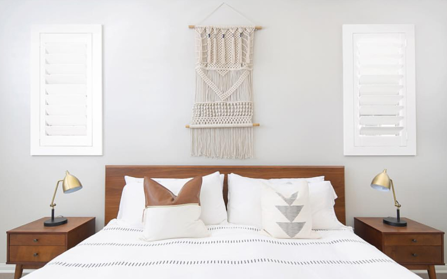 Custom-fitted louvered shutters provide excellent nighttime privacy in Bakersfield. Photo Credit: Audrey Crisp Louvered shutters in a bedroom.