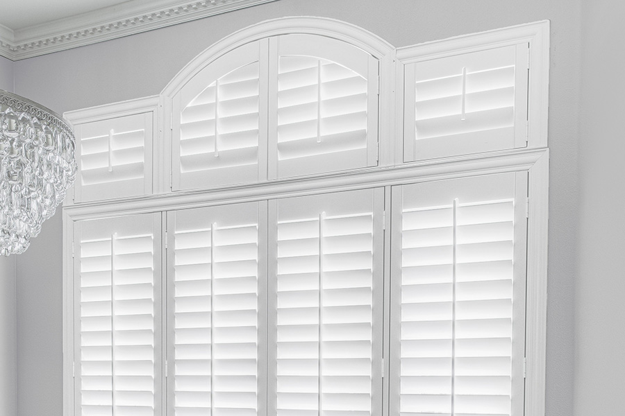 Customize your Palladian windows with white Polywood shutters in Bakersfield. White Polywood Palladian windows in a dining room.