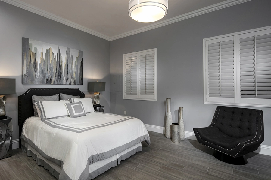 Close your custom Polywood shutters to beat the heat and keep your Bakersfield bedroom cool. White Polywood shutters on bedroom windows