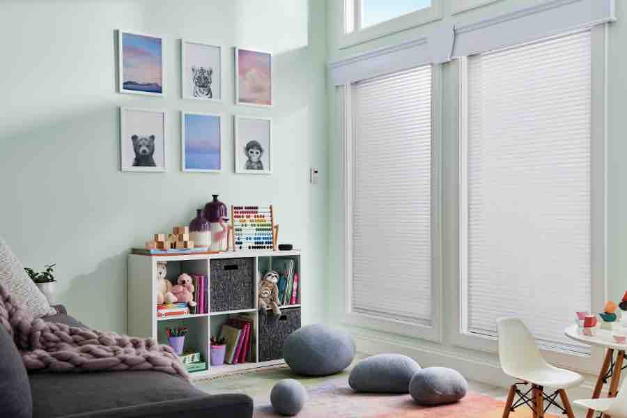 Find colorful or neutral-hued window shades to complement your family room decor. White window shades on windows in a green family room