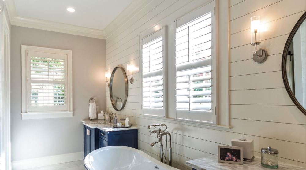 Bakersfield bathroom with white plantation shutters.