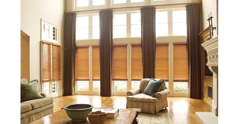 Bakersfield great room with wooden blinds and full-length drapes. Bakersfield great room with wooden blinds and full-length drapes.