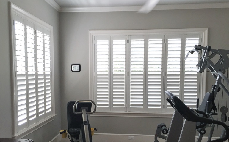 Bakersfield exercise room with shuttered windows.