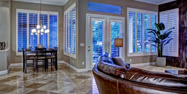 Bakersfield great room with plantation shutters and tile floor.