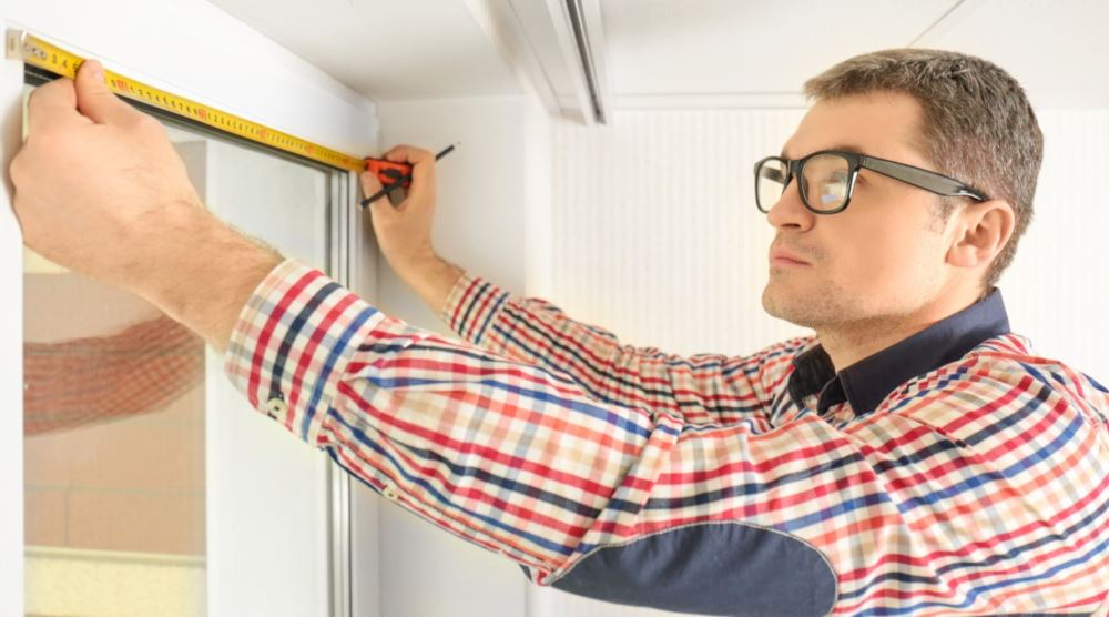 Man measuring windows in Bakersfield
