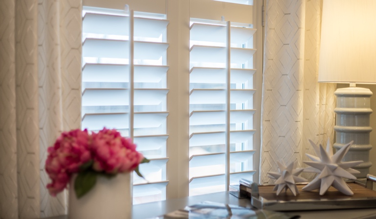 Plantation shutters by flowers in Bakersfield