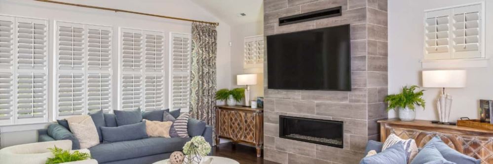 Plantation shutters in Golden Hills living room with fireplace