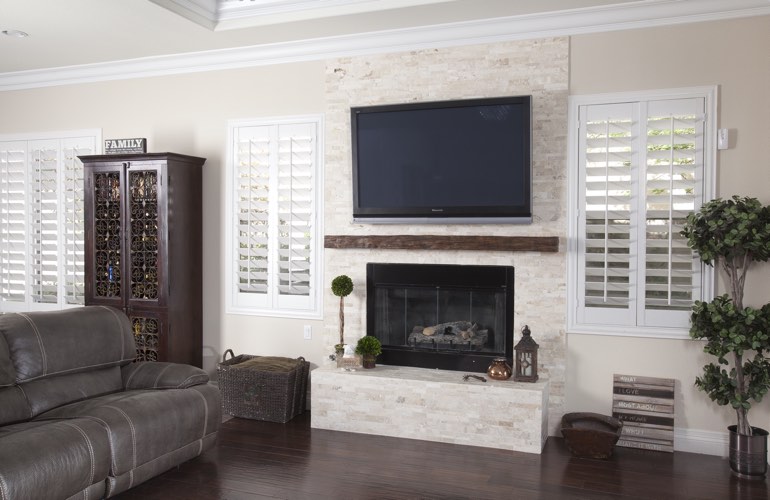 White plantation shutters in a Bakersfield living room with solid hardwood floors.