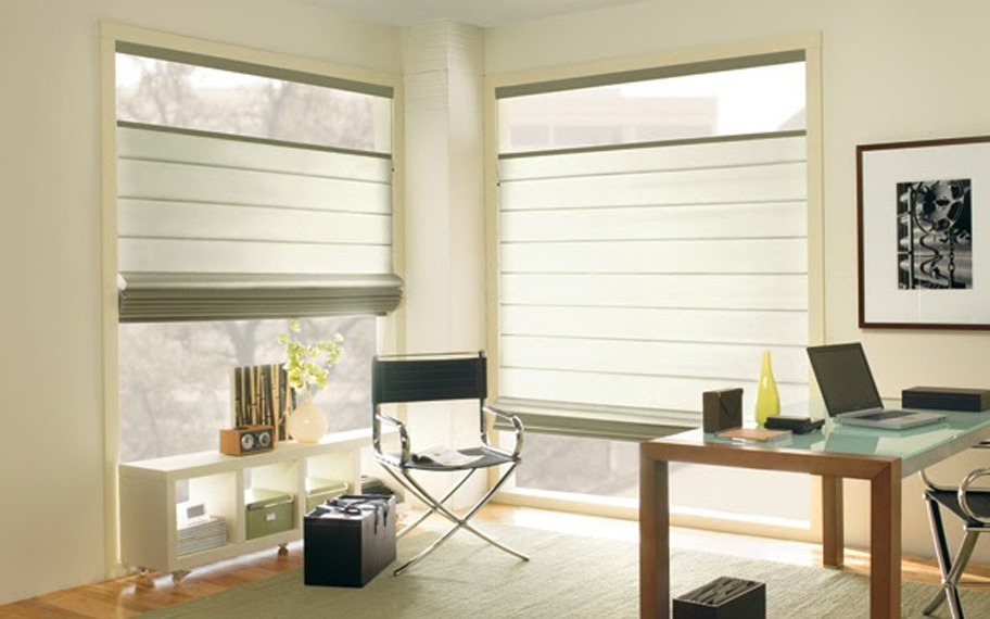 Upgrade your windows with stylish window shades or shutters in Bakersfield. Stylish sheer shades in the corner of a modern office.