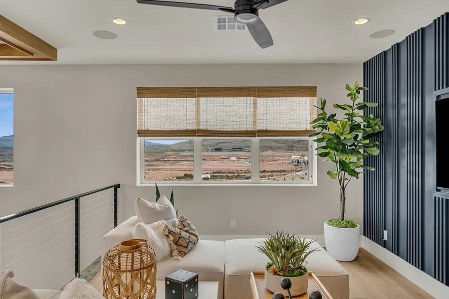 Bakersfield homeowners who want eco-friendly home fixtures should consider natural woven shades. Natural brown woven shades on a window in a stylish sitting area