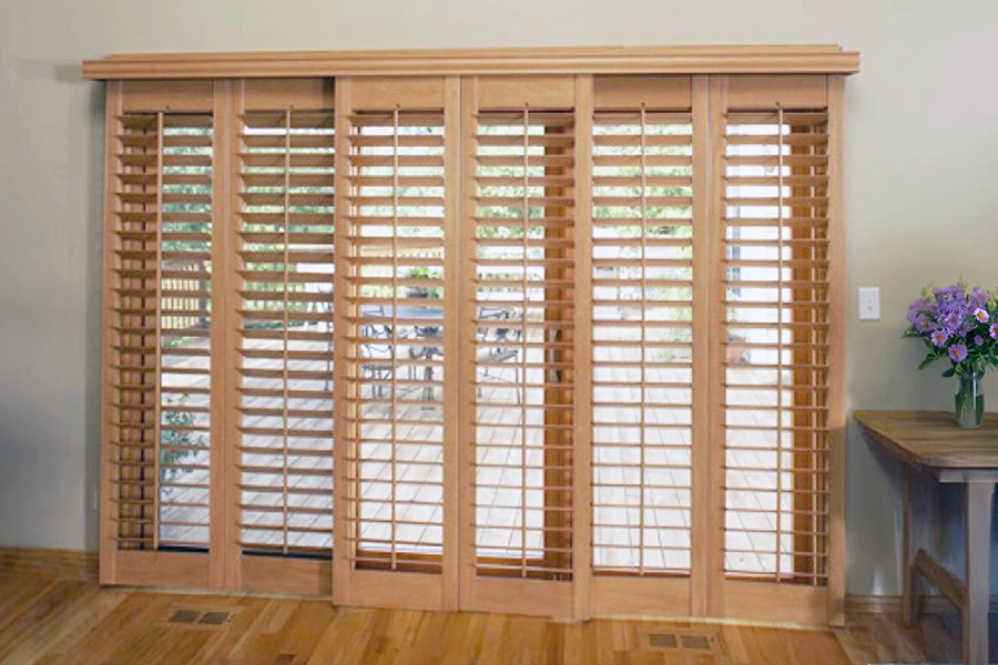 Wood shutters installed on a panel track over a sliding glass door