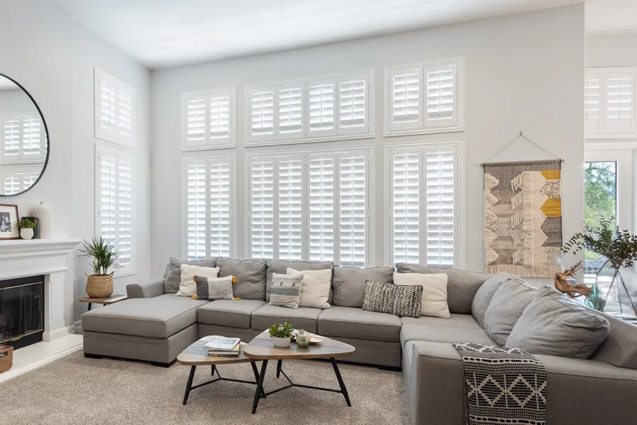 White Polywood shutters on tall living room windows